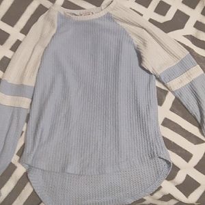 It is a blue and white long sleeve shirt.